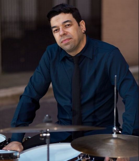 Rafael Barata sitting in front of drums